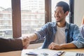 New house / home moving and relocation concept. Happy asian couple shaking hands with real estate consultant Royalty Free Stock Photo