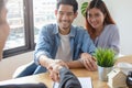 New house / home moving and relocation concept. Happy asian couple shaking hands with real estate consultant Royalty Free Stock Photo