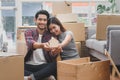 New house / home moving and relocation concept. Happy asian new married couple looking at each other face after moving. Royalty Free Stock Photo