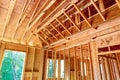 New house interior unfinished construction with wooden framing beams