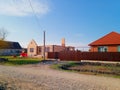 New house with an orange roof and a brown fence