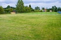 A house plot with well maintained grass and compost box in the corner