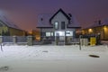 New house with stone fence at snowy night Royalty Free Stock Photo