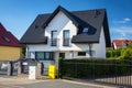 New house with white walls and black roof