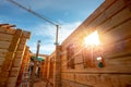 New house wooden log construction interior with exposed framing roof with sun light Royalty Free Stock Photo