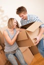 New house: Young couple moving box, unpacking Royalty Free Stock Photo