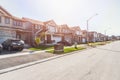 New houses along a street in a housing development on a sunny autumn day