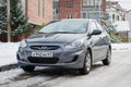 New Hyundai Solaris Accent parked in winter street.