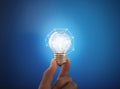 New ideas, innovation, networking and saving energy concepts. Hand holding glowing light bulb Royalty Free Stock Photo