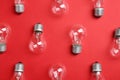 New incandescent lamp bulbs on red background Royalty Free Stock Photo