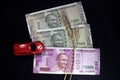 Indian currencies. 500, and 2000 rupee notes with Wheat grains and red color toy car. Indian currency isolated on black background Royalty Free Stock Photo