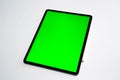 IPad and iPhone, new tablet on a white background with a pen, and green screen top view Royalty Free Stock Photo