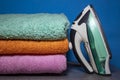 New Iron and Ironing Towels on the Table. Iron and Ironed Linen on a Wooden Surface Royalty Free Stock Photo