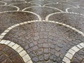 New italian paving made with porphyry stone blocks and white marble of cubic shape in a pedestrian zone