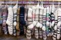 New knitted wool socks of different colors and ornaments hanging in a row Royalty Free Stock Photo