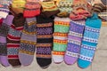 New knitted wool socks of different colors and ornaments hanging in a row Royalty Free Stock Photo