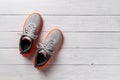 New laced up textile sneakers on the gray wooden floor