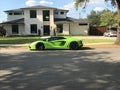 A new Lamborghini Aventador parked outside a home