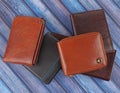 New leather multicolored wallets on blue wooden background