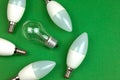 New LED light bulbs and old fluorescent light bulb together, energy saving and eco friendly concept. Green background Royalty Free Stock Photo