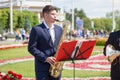 New Life Brass band classical quintet of brass wind musical instruments, orchestra performs music, man musician plays saxophone