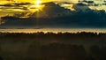 New life concept: gorgeous an promising scene of dark mountain range and foggy valley in the first rays of the sun beaming through