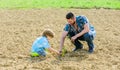 New life. soils fertilizers. rich natural soil. Eco farm. father and son planting flowers in ground. earth day. small