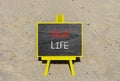 New life symbol. Concept words New life on wooden blocks on a beautiful black blackboard on a beautiful beach sand background. Royalty Free Stock Photo