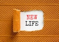 New life symbol. Concept words New life on wooden blocks on a beautiful white paper on a beautiful brown paper background. Royalty Free Stock Photo