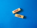 New life symbol. Wooden blocks with words New life. Beautiful blue background. Business and New life concept. Copy space Royalty Free Stock Photo