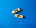 New life symbol. Wooden blocks with words New life. Beautiful blue background. Business and New life concept. Copy space Royalty Free Stock Photo