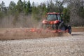 New Lisbon, Wisconsin USA - May 4th, 2022: Farmer driving a Case 305 Magnum tractor while pulling a plow to plow up a farming fiel