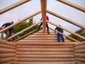 Carpenters assemble timber frame with common rafters on cabin roof