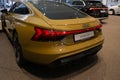 new Luxury Electric Car Audi e-tron GT, taillights, yellow limousine rear view in showroom, Automotive Innovation in automotive