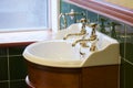 New luxury hotel vintage brass gold plated pillar taps in ensuite bathroom at wash basin