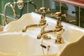 New luxury hotel vintage brass gold plated pillar taps in ensuite bathroom at wash basin