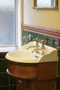 New luxury hotel vintage brass gold plated pillar taps in ensuite bathroom at wash basin