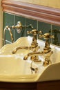 New luxury hotel vintage brass gold plated pillar taps in ensuite bathroom at wash basin Royalty Free Stock Photo