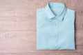 New man blue shirt on wood background. Royalty Free Stock Photo