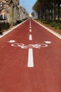 New marking bike path. White bicycle symbol and two oposite arrows on red asphalt lane, road. Bicycle path in the city Royalty Free Stock Photo