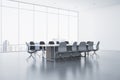 New meeting room interior with reflections on concrete flooring and panoramic window with city view and daylight. Commercial Royalty Free Stock Photo