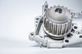 New metal automobile pump for cooling the engine of a water pump on a gray background. The concept of new spare parts