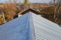 New metal corrugated roof on apartment house an old shabby roof at background.