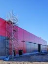 New metal frame building, covered with sandwich panels in red and gray