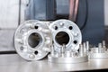 New metal mold of wheel spacers with bolts. CNC industry