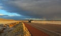 NEW MEXICO, USA - NOVEMBER 22, 2019: car on the road during a red sunset and thunderclouds on the background of the Guadalupe Royalty Free Stock Photo