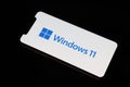 New Microsoft Windows 11 logo on mobile phone screen.
