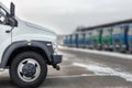 New middle size trucks at dealership parking outdoors at winter. Truck service and maintenance. Delivering and warehouse service Royalty Free Stock Photo