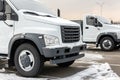 New middle size trucks at dealership parking outdoors at winter. Truck service and maintenance. Delivering and warehouse service Royalty Free Stock Photo