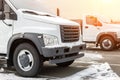 New middle size trucks at dealership parking outdoors at winter. Truck service and maintenance. Delivering and warehouse service Royalty Free Stock Photo